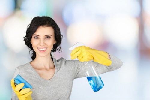 Office cleaner maintaining floors and desks in West London workspace