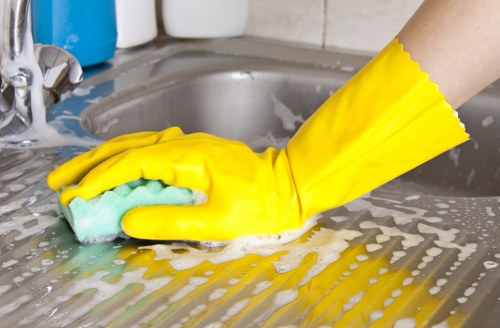 Trained Shepherdsbush cleaner using safe working practices indoors